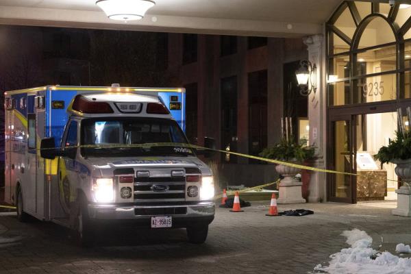 An ambulance is parked outside the lobby of a co<em></em>ndominium building following a fatal shooting in Vaughn, Ontario, on Sunday, Dec 18, 2022. 