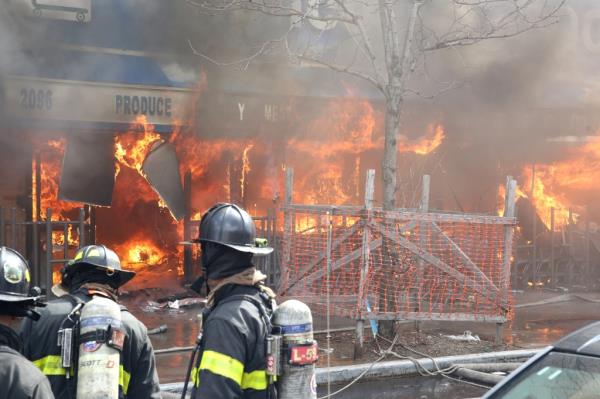 Flames shoot out of windows at the Co<em></em>ncourse Food Plaza at 2096 Grand Concourse.