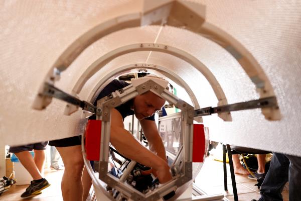 Bio<em></em>nic engineering student Joshua Biehn, 27, makes the final adjustments to the Chelo<em></em>nia submarine in Arinaga