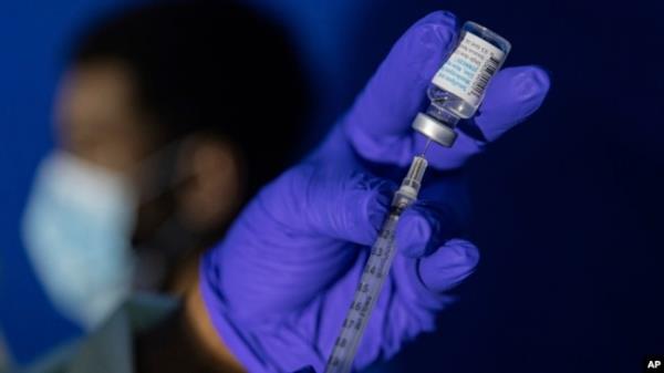 FILE - A nurse practitio<em></em>ner prepares a syringe with the Mpox vaccine before inoculating a patient at a vaccinations site in the Brooklyn borough of New York City, Aug. 30, 2022.