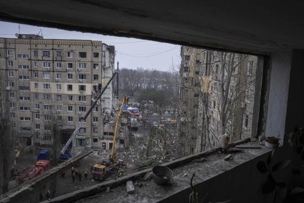 Rescue workers clear the rubble from an apartment building that was destroyed in a Russian rocket attack at a residential neighbourhood in the southeastern city of Dnipro, Ukraine, Monday, Jan. 16, 2023. 