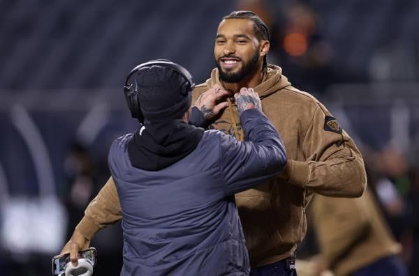 Bears defensive end Mo<em></em>ntez Sweat has a microphone attached to his hoodie as players warm up for a game against the Panthers at Soldier Field on Nov. 9, 2023.