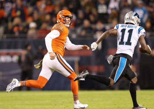 Bears punter Trenton Gill chases after Panthers wide receiver Ihmir Smith-Marsette as Smith-Marsette returns a punt for a touchdown in the first quarter at Soldier Field on Nov. 9, 2023.