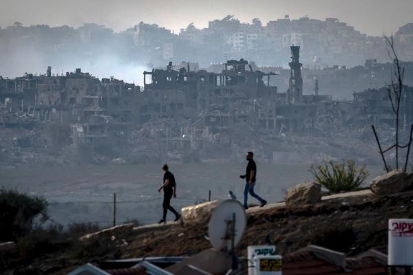 Men walk along the border of Gaza in southern Israel on November 13, 2023.