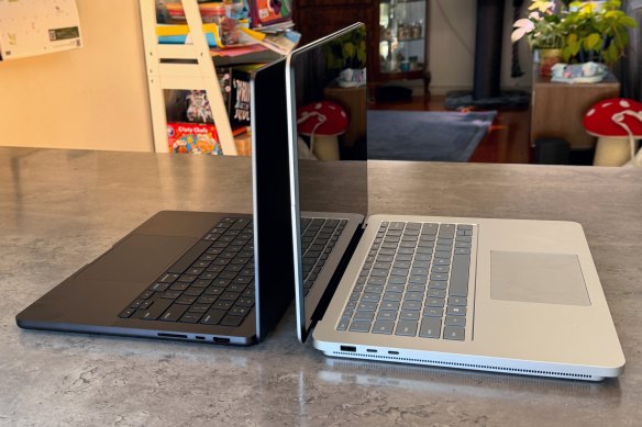 The Surface Laptop Studio 2 (right) is bigger and heavier than the latest MacBook Pro, but whether it’s more powerful depends on how you co<em></em>nfigure the devices.