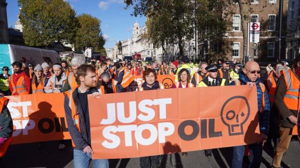 Just Stop Oil protesters take part in a walking protest blocking Whitehall in central London. Picture date: Mo<em></em>nday November 6, 2023. PA Photo. See PA story POLICE Oil. Photo credit should read: Lucy North/PA Wire