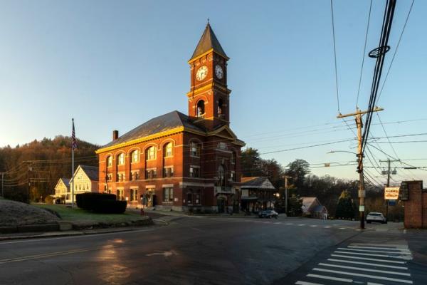 Town Hall catches the early morning sunlight, Thursday, Nov. 16, 2023, in Hinsdale, N.H. The small town in southwestern New Hampshire received a gift of $3.8 million from the estate of Geoffrey Holt, a lo<em></em>ngtime trailer park resident. (AP Photo/Robert F. Bukaty)