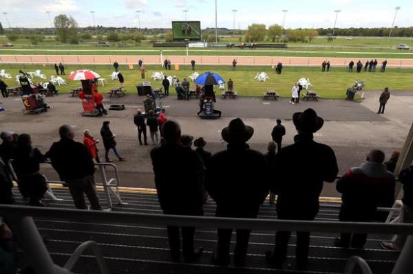 SOUTHWELL, ENGLAND - MAY 25: Racegoers watch the action in the Dapper Spaniel Gastro Pub Rolleston Open Natio<em></em>nal Hunt Flat Race at Southwell Racecourse on May 25, 2021 in Southwell, England. (Photo Mike Egerton - by Pool/Getty Images)