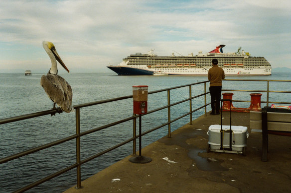 A man fishes off a pier at the ferry terminal for the California coastal island of Santa Catalina.
