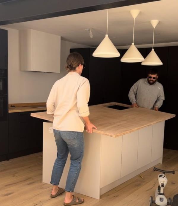 Kitchen before with Charlotte and Bobby placing tabletop