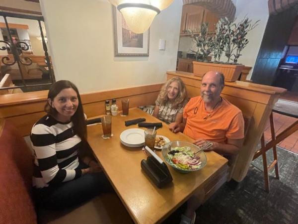 The author and her parents celebrating a recent writing success at the Olive Garden wher<em></em>e she used to work.