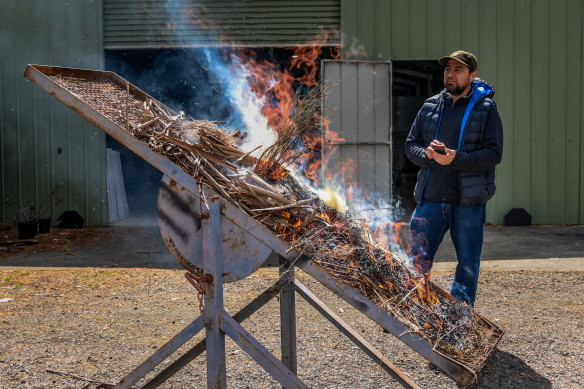 Julio Najera Umana watching the fire table with dry vegetation ablaze. 
