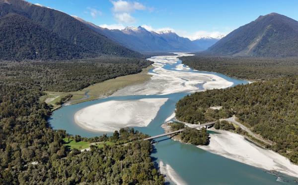 A view of the Arawhata River and bridge looking inland towards the Southern Alps, near Jackson Bay on the West Coast.