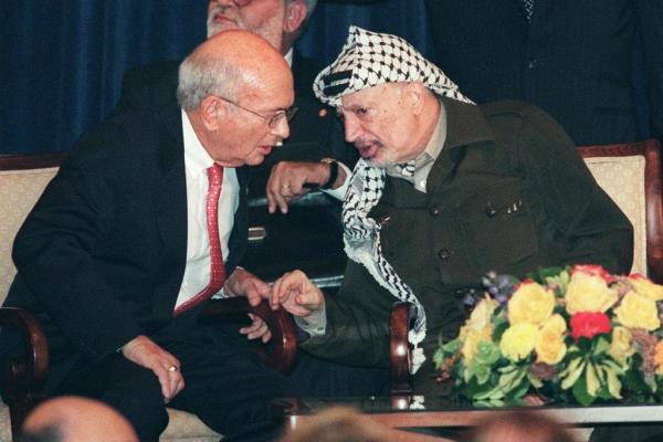 Yasser Arafat, President of the Palestinian Authority (R), talks with S. Daniel Abraham, chairman of the Center for Middle East Peace and Eco<em></em>nomic Cooperation (L), after Arafat gave a speech on the Middle East peace process in 1998.