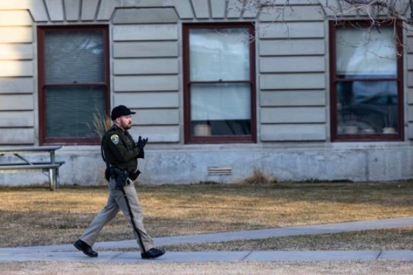 A Mo<em></em>ntana High Patrol trooper walks the perimeter of the Mo<em></em>ntana State Capitol after a bomb threat 