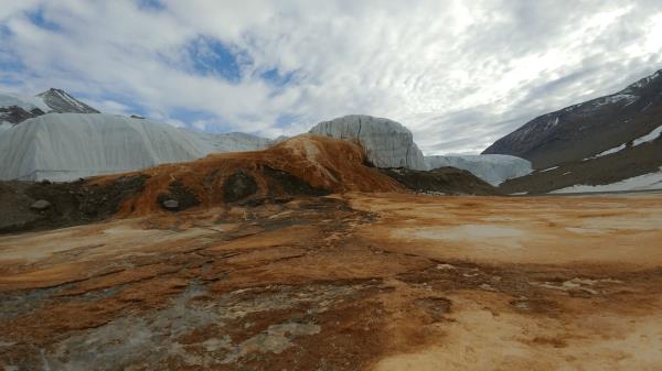 Blood Falls, Antarctica, wher<em></em>e microbes live under the ice. Iron and other elements from the bedrock below the ice become oxidized when it interacts with air, producing the rusty red coloring.