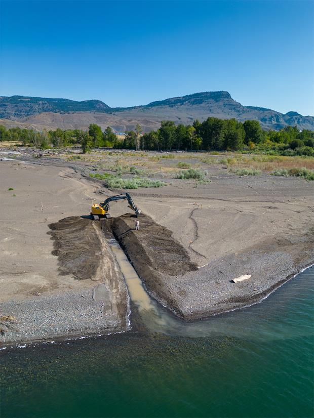 An excavator cut a channel through sediment buildup at the mouth of the Tranquille River in southern British Columbia to reestablish flow into Kamloops Lake and let thousands of salmon move upriver in time to spawn.