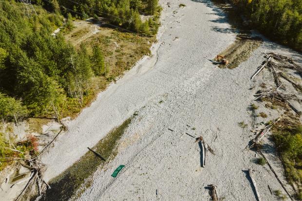 In an emergency respo<em></em>nse to the drought, an excavator is used to reestablish flow on the Indian River in southwestern British Columbia September, 2023. 
