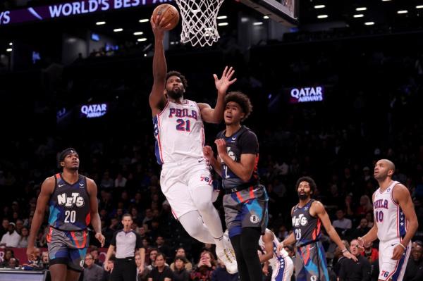 Joel Embiid scores during the 76ers' win over the Nets on Nov. 19, 2023. 