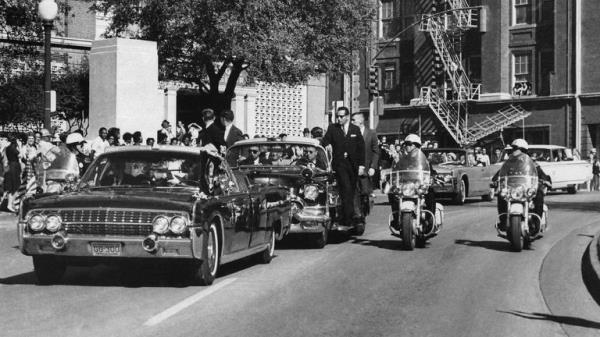 President John F Kennedy's hand reaches toward his head within seco<em></em>nds of being fatally shot