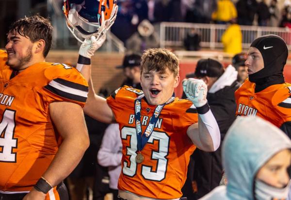 Byron’s Carsen Behn, center, celebrates as the team leaves the field after taking a group photo after the champio<em></em>nship game on Nov. 24, 2023.