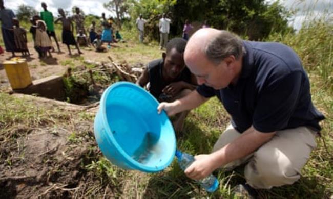 John examines a polluted well in the village of Abia, north-east Uganda, Africa.
