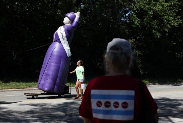 An inflatable Mother Jo<em></em>nes is held in place by a parade participant during the Chicago Labor Day Parade along South Cottage Grove Avenue in the Pullman neighborhood on Sept. 2, 2023, in Chicago.