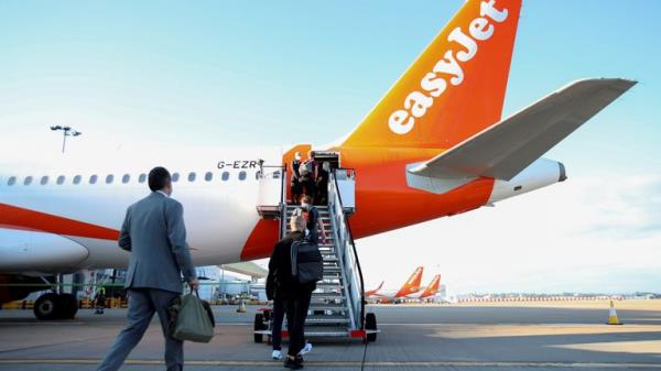 Passengers board a plane as EasyJet restarts its operations amid the coro<em></em>navirus disease (COVID-19) outbreak at Gatwick Airport, in Gatwick, Britain June 15, 2020. REUTERS/Peter Cziborra