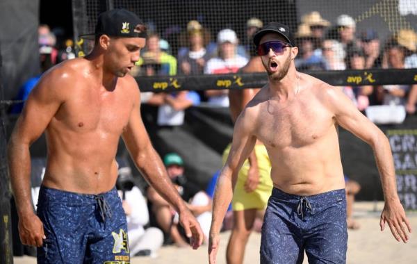 Theo Brunner, right, and teammate Trevor Crabb after winning a point in the Hermosa Beach Open on July 8, 2023.