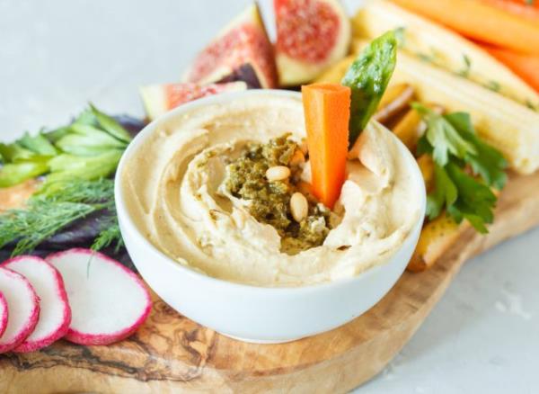 bowl of hummus with veggies on board, co<em></em>ncept of the best 100-calorie snacks for weight loss