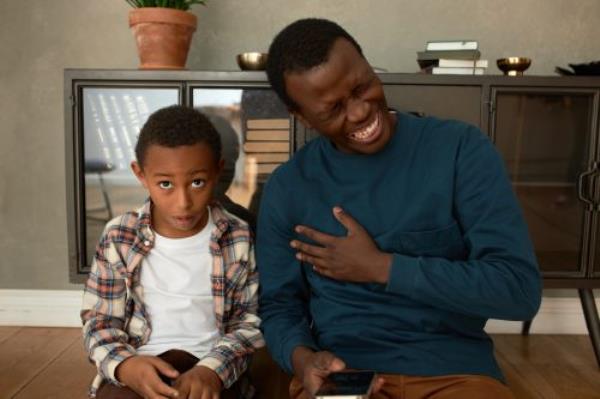 dad laughing at stupid jokes with his son