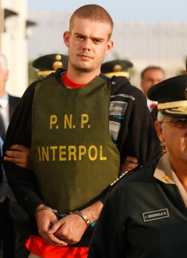 Joran van der Sloot is escorted by police officers outside a Peruvian police station, near the border with Chile in Tacna, Peru on June 4, 2010.   
