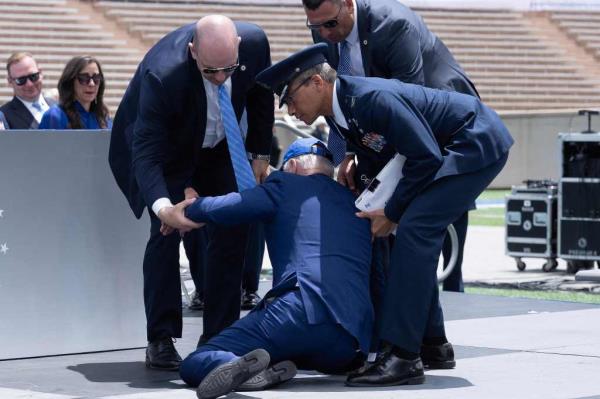 US President Joe Biden is helped up after falling during the graduation ceremony at the United States Air Force Academy.
