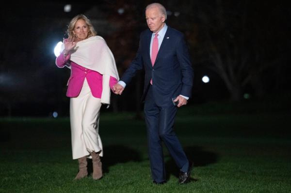 First lady Jill Biden waves to the press as she and President Joe Biden walk across the South Lawn of the White House on Sunday.