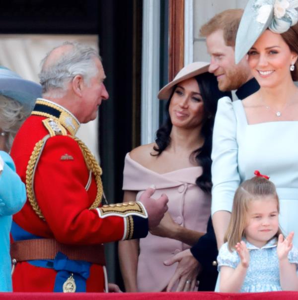 King Charles, Meghan, Duchess of Sussex and Prince Harry, Duke of Sussex stand on the balcony of Buckingham Palace.