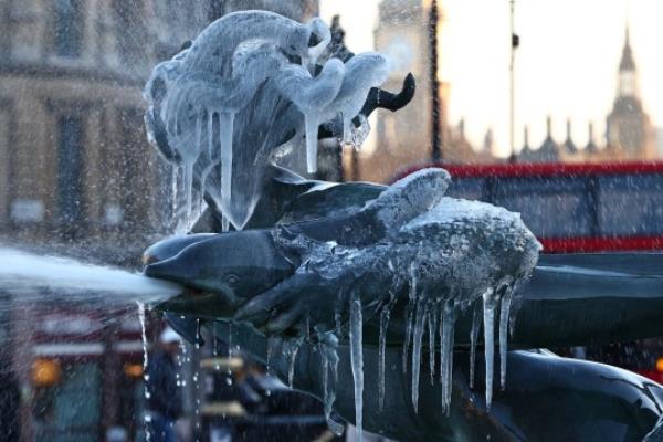 Icicles hang from a frozen fountain sculpture in Trafalgar Square in central Lo<em></em>ndon on January 16, 2024, as cold Arctic air brings snow and freezing temperatures to the UK. (Photo by HENRY NICHOLLS / AFP) (Photo by HENRY NICHOLLS/AFP via Getty Images)