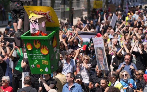Protesters against pension reform carry an effigy of the president