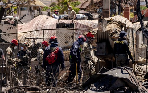 Search and rescue team members work in the area devastated by a wildfire in Lahaina, Hawaii