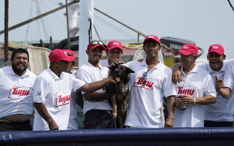 The crew of the Mexican tuna boat Maria Delia pose for photos with 'brave' Bella