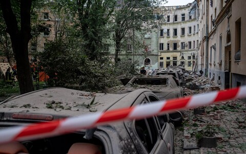 Cars lie wrecked or heavily damaged next to a four-storey residential building that was struck by a missile attack on July 6, 2023 in Lviv, Ukraine. 