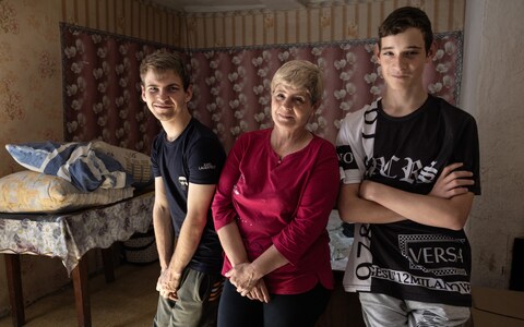 Natalia Lysevich, centre, her son Igor Lysevich, and Vasily Savchenko