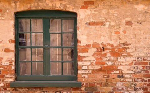 Natural choice: a wooden window f<em></em>rame set in a wall in Ticknall, Derbyshire