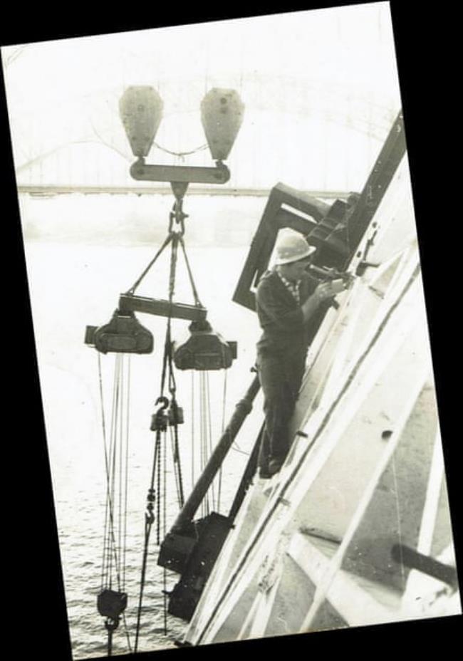 Up in the air: a worker surveys the Sydney Opera House during construction.
