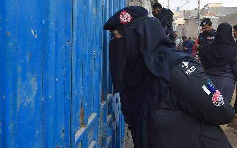 Pakistani police officials co<em></em>nduct a search operation for undocu<em></em>mented immigrants