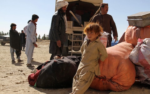 A young boy by his family's belo<em></em>ngings in a makeshift camp in Ghazni