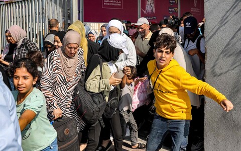 People walk through a gate to enter the Rafah border crossing to Egypt in the southern Gaza Strip