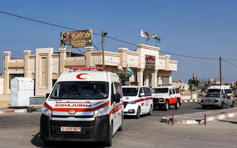 Palestinian health ministry ambulances arrive outside the Rafah border crossing in the southern Gaza Strip