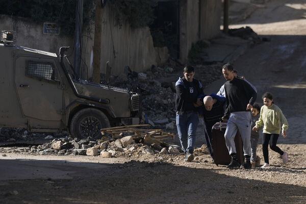 Palestinians flee an Israeli military raid on Jenin refugee camp in the West Bank on Wednesday. Picture: AP Photo/Majdi Mohammed Palestinians flee an Israeli military raid on Jenin refugee camp in the West Bank on Wednesday. Picture: AP Photo/Majdi Mohammed