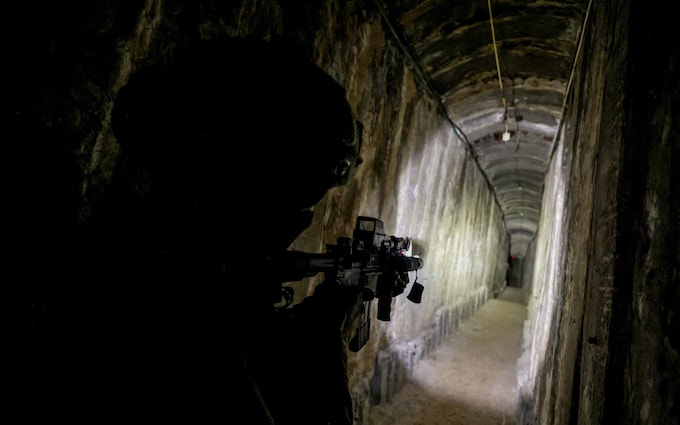 An Israeli soldier walks down a tunnel underneath Gaza