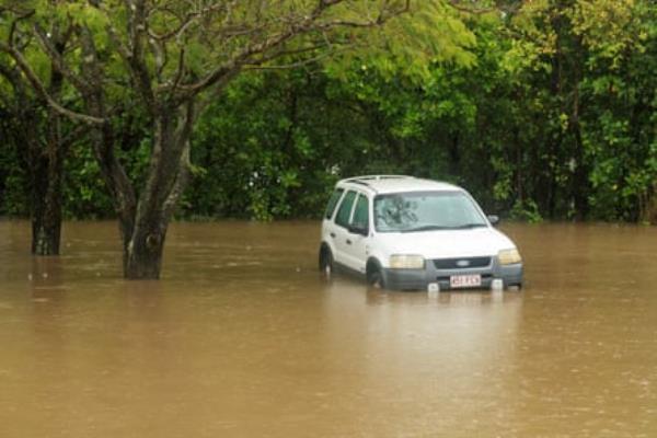 A car inundated with water nearby the Barron River in Cairns